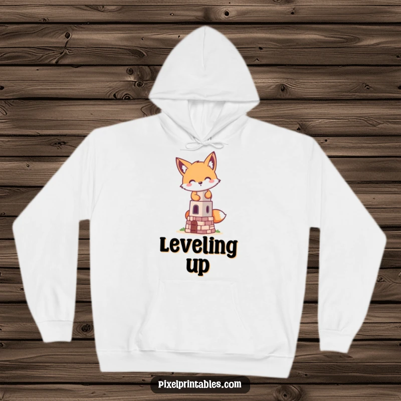 Funny pixelated fox building a tiny pixelated tower from a cozy hoodie, a retro gaming design for playful warmth.